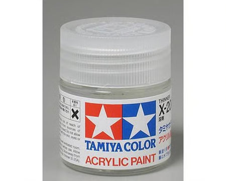 Tamiya Color acrylic paint jar with white lid on a gray background